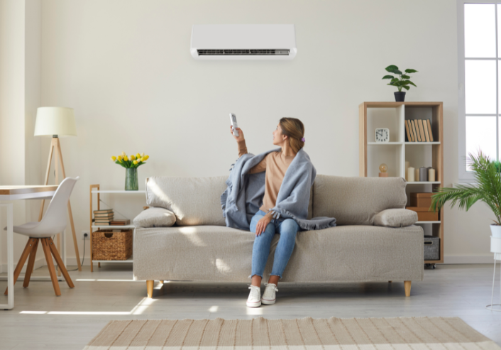 Woman setting her ac/heater in her living room