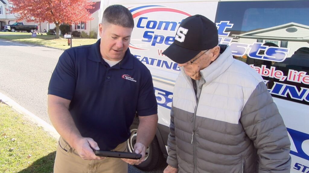 Technician talking to a homeowner about HVAC options