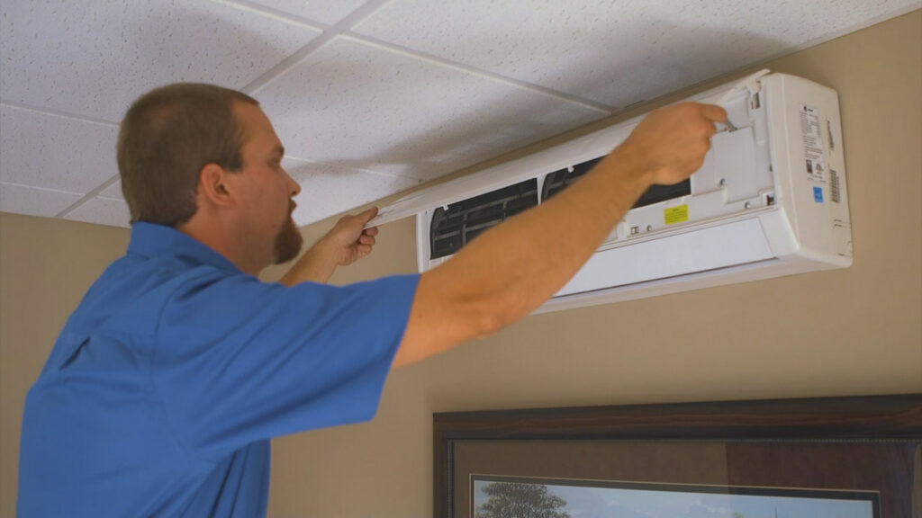 man working on ac and duct work