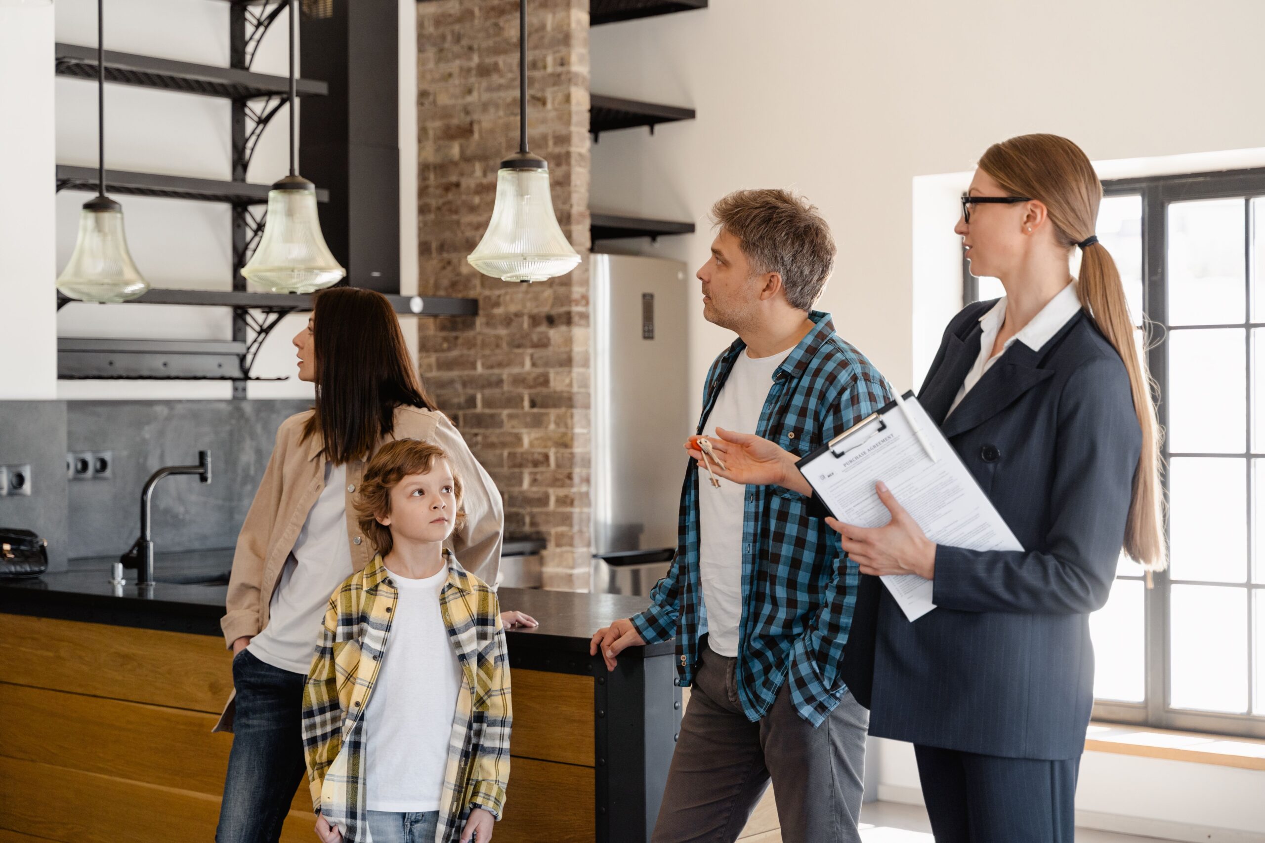 Family being shown a home by a real estate agent